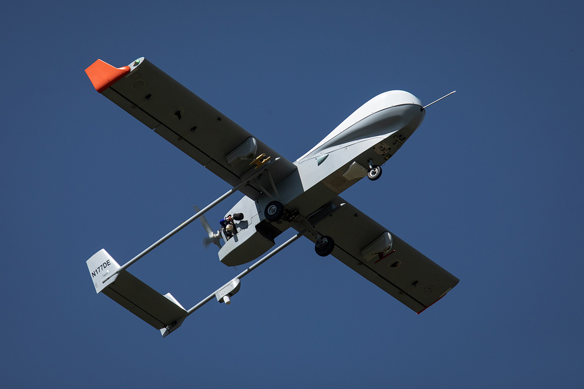 The underside of the ArcticShark uncrewed aerial system is seen in flight.