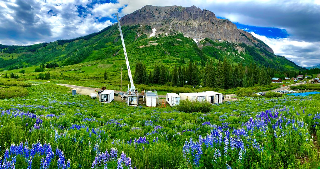 Over three and a half days in June 2021, this site in Gothic, Colorado, went from an empty construction pad to eight cargo containers hosting much of the instrumentation associated with the Surface Atmosphere Integrated Field Laboratory (SAIL) campaign. In this picture, construction of the second ARM Mobile Facility (AMF2) is finished for the day and the crane is parked. John Bilberry and David Chu, who are managing the SAIL AMF2 deployment for ARM, stand atop the second container from the left.