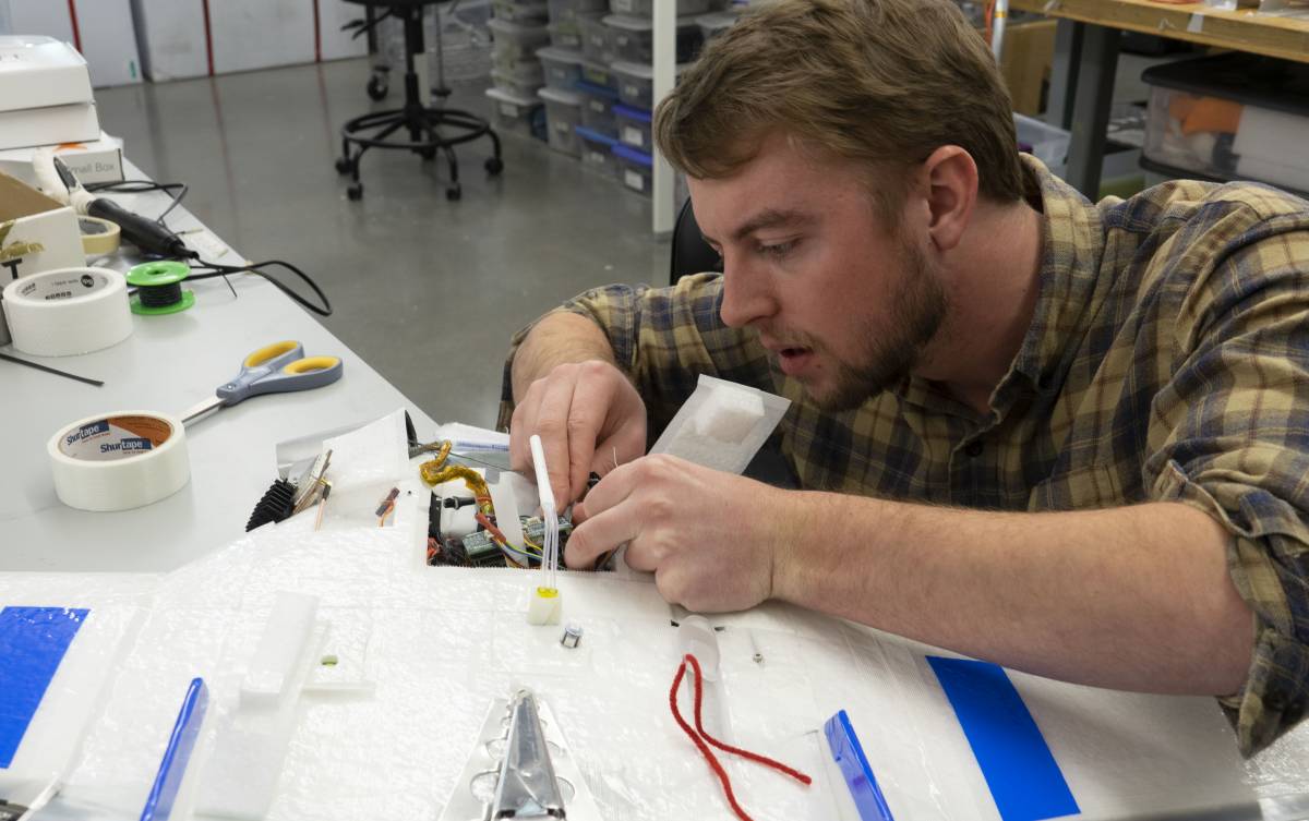 Colorado University (CU) engineering graduate student Jonathan Hamilton prepares an unmanned aerial system for its first test flight in Boulder, Colorado. This UAS is what Gijs de Boer describes as "the workhorse" of his research project on the MOSAiC expedition. Photo by Julia Medeiros. 